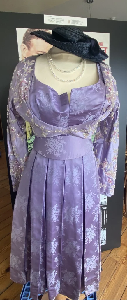 Close-up of a lilac purple dress with long embroidered sleeves, part of the Maureen O'Hara collection.